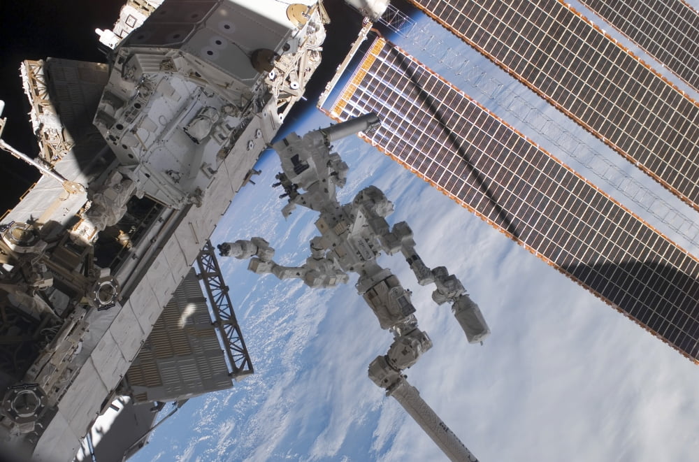 The Canadian-built Dextre robotic system in the grasp of the robotic Canadarm2 Canvas Art - Stocktrek Images (34 x 23)