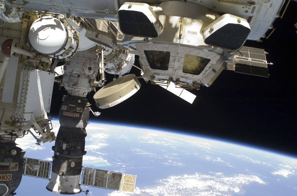 The Cupola of the International Space Station and a docked Russian Progress spacecraft Canvas Art - Stocktrek Images (34 x 23)
