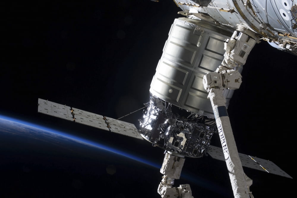 The Cygnus spacecraft attached to the Harmony Node in the grasp of Canadarm2 Canvas Art - Stocktrek Images (35 x 23)