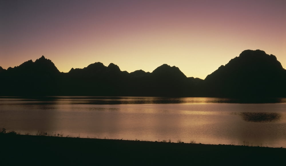 The Grand Tetons silhouetted in the evening light in front of Jackson Lake Grand Teton National Park Wyoming Canvas Art - Panoramic Images (20 x 12)