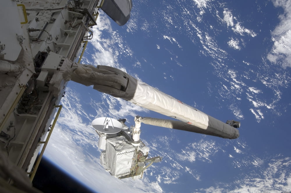 The Integrated Cargo Carrier in the grasp of the shuttles remote manipulator system arm Canvas Art - Stocktrek Images (35 x 23)
