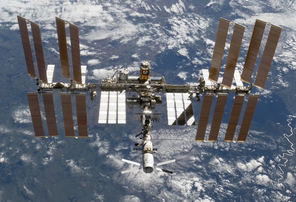 The International Space Station backdropped by a blue and white Earth Canvas Art - Stocktrek Images (34 x 24)