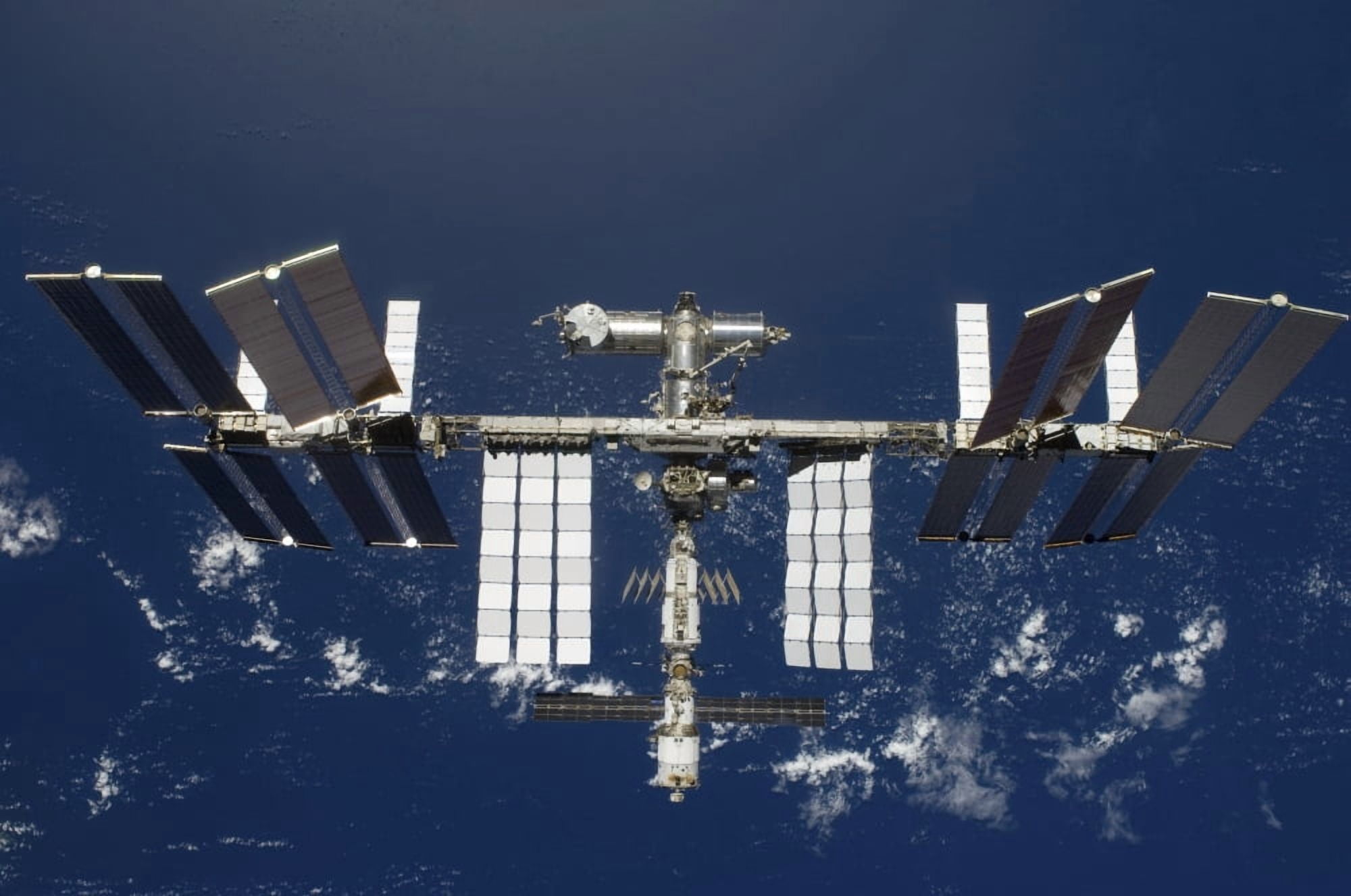 The International Space Station backdropped by a blue and white Earth Canvas Art - Stocktrek Images (35 x 23)