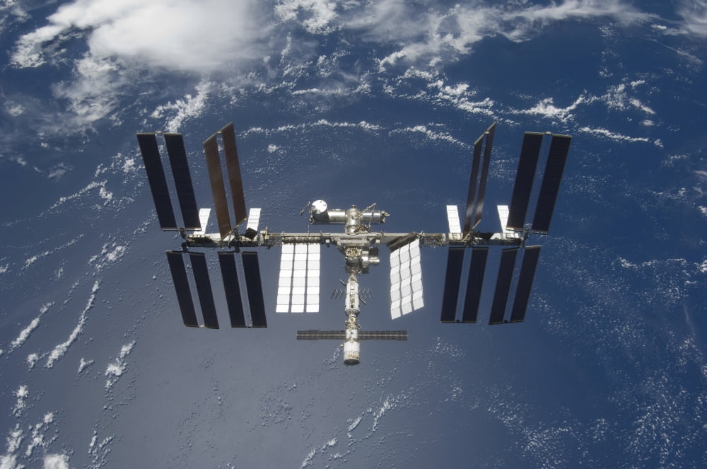 The International Space Station backdropped by a blue and white Earth Canvas Art - Stocktrek Images (35 x 23)