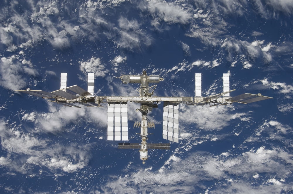 The International Space Station backdropped by a blue and white Earth Canvas Art - Stocktrek Images (35 x 23)