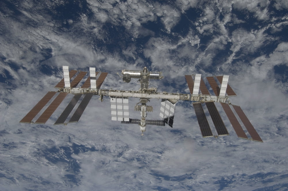 The International Space Station backdropped by a blue and white Earth Canvas Art - Stocktrek Images (35 x 23)