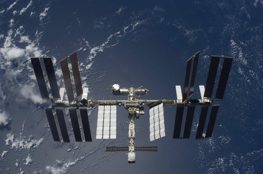 The International Space Station backdropped by a blue and white Earth Canvas Art - Stocktrek Images (35 x 23)