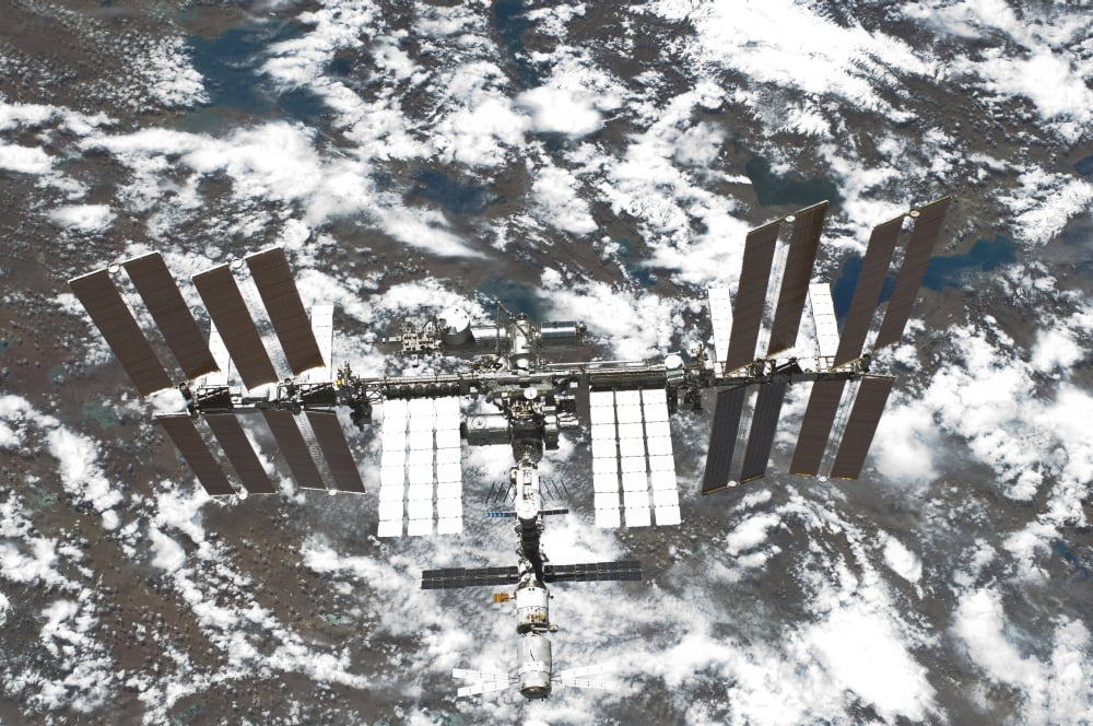 The International Space Station backdropped by a colorful part of Earth Canvas Art - Stocktrek Images (34 x 23)