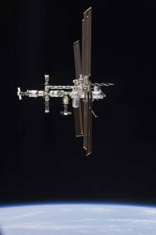 The International Space Station in orbit above Earth Canvas Art - Stocktrek Images (23 x 34)