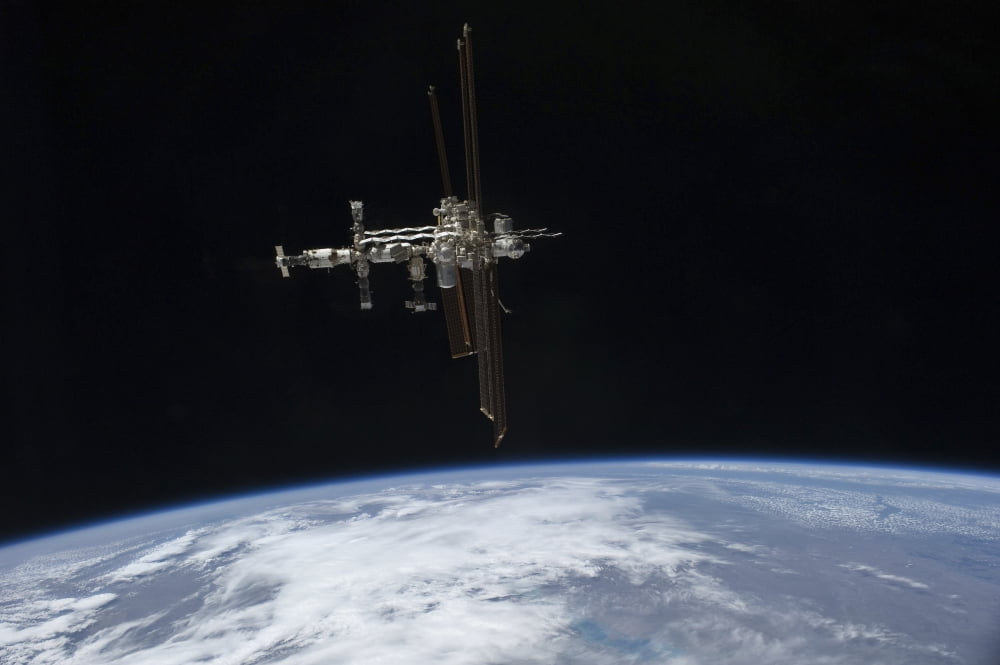 The International Space Station in orbit above Earth Canvas Art - Stocktrek Images (34 x 23)