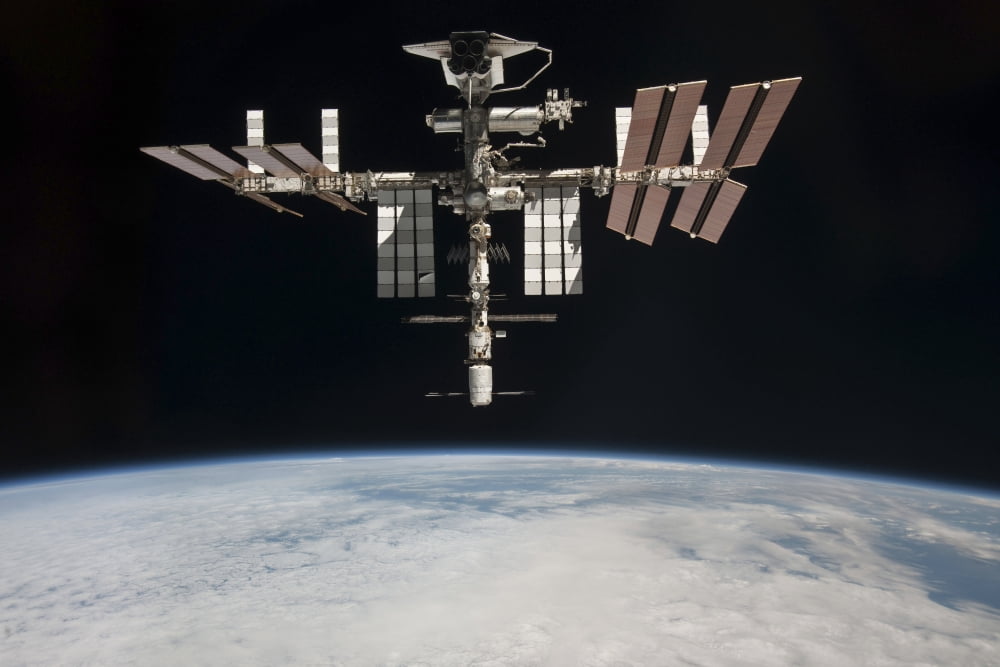 The International Space Station in orbit above Earth Canvas Art - Stocktrek Images (34 x 23)