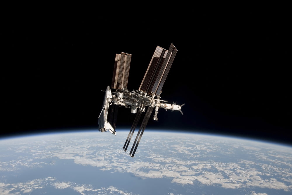 The International Space Station in orbit above Earth Canvas Art - Stocktrek Images (34 x 23)