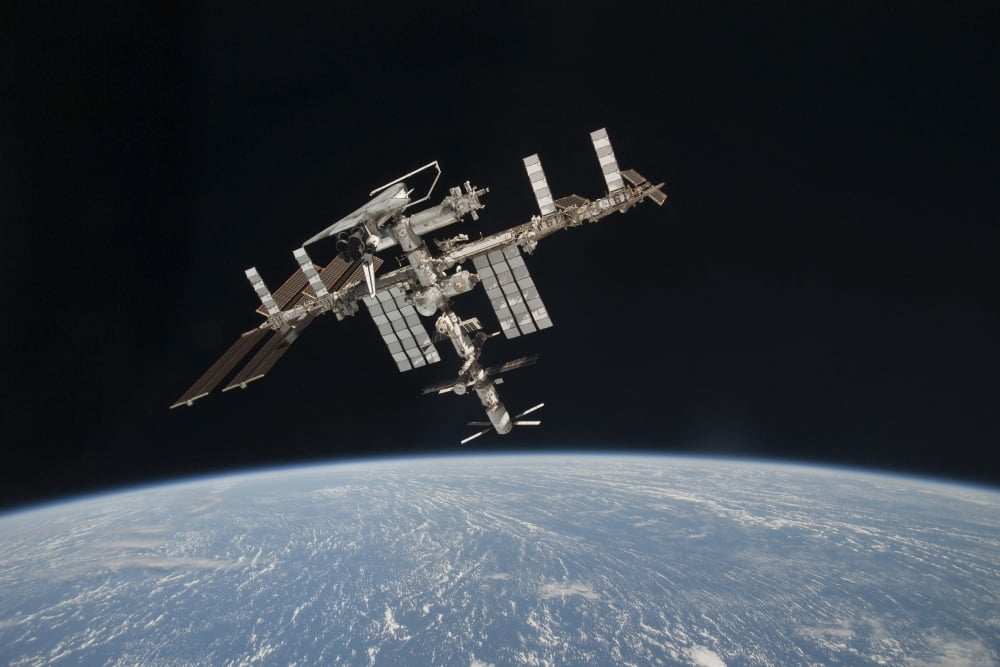 The International Space Station in orbit above Earth Canvas Art - Stocktrek Images (34 x 23)