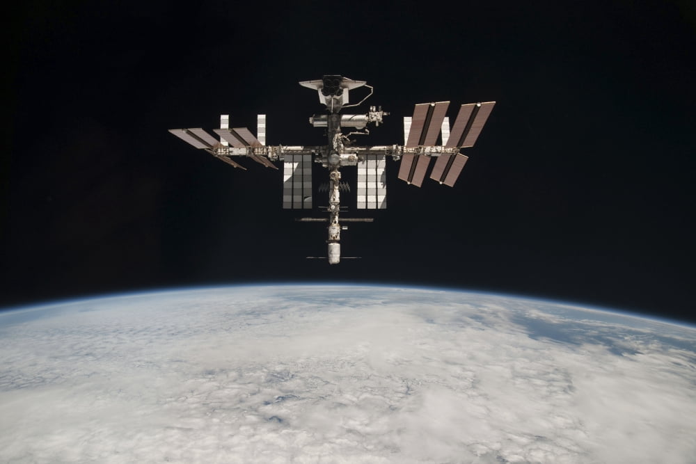 The International Space Station in orbit above Earth Canvas Art - Stocktrek Images (34 x 23)