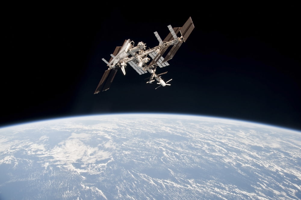 The International Space Station in orbit above Earth Canvas Art - Stocktrek Images (34 x 23)