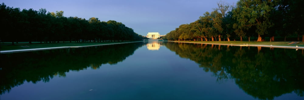 The Lincoln Memorial at sunrise with mirror image from reflecting pool in Washington DC Canvas Art - Panoramic Images (27 x 9)