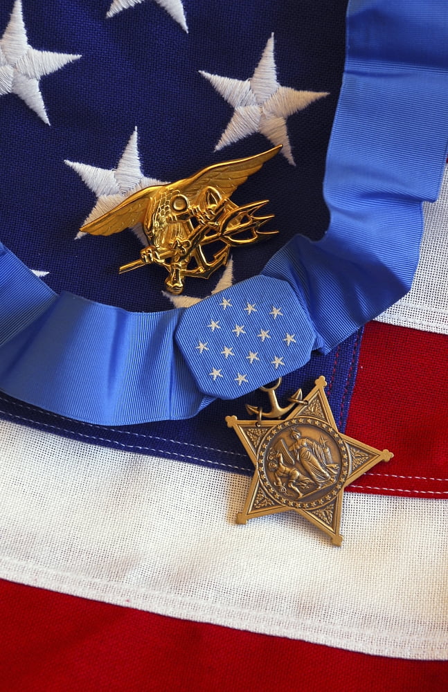 The Medal of Honor rests on a flag beside a SEAL trident Canvas Art - Stocktrek Images (23 x 35)