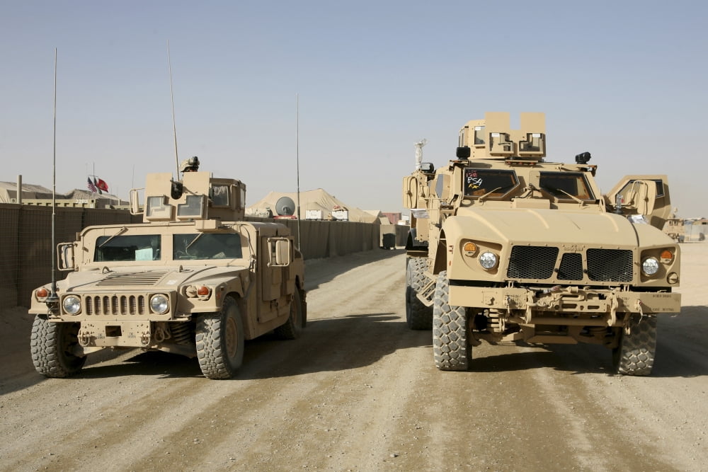 The Mine Resistant Ambush Protected All Terrain Vehicle and its predecessor the humvee Canvas Art - Stocktrek Images (35 x 23)