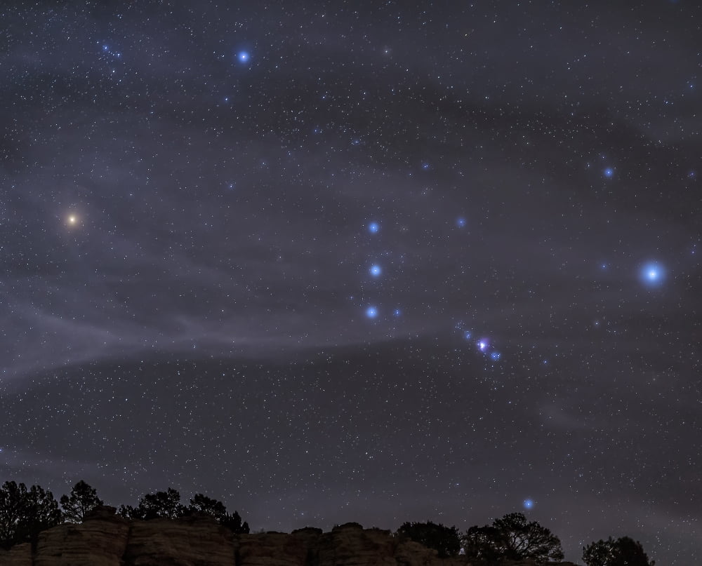 The Orion constellation rises over a hill through high thin clouds Canvas Art - John DavisStocktrek Images (31 x 25)