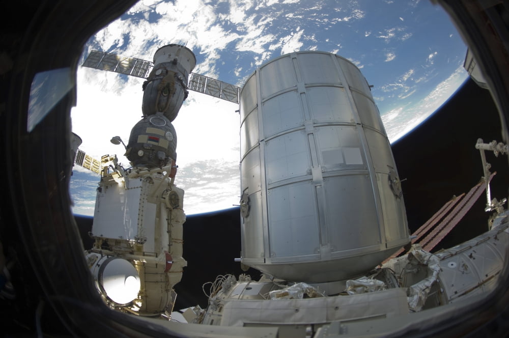 The Permanent Multipurpose Module and a docked Russian Soyuz spacecraft Canvas Art - Stocktrek Images (34 x 23)
