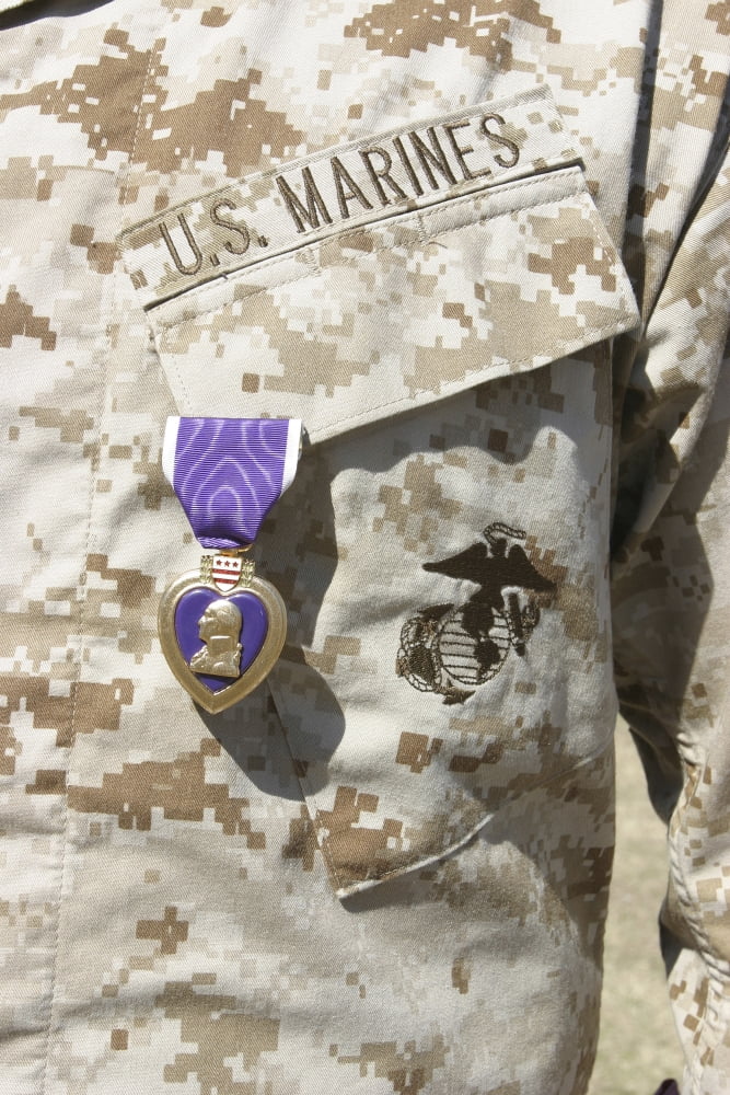 The Purple Heart award hangs over the heart of a US Marine Canvas Art - Stocktrek Images (23 x 34)