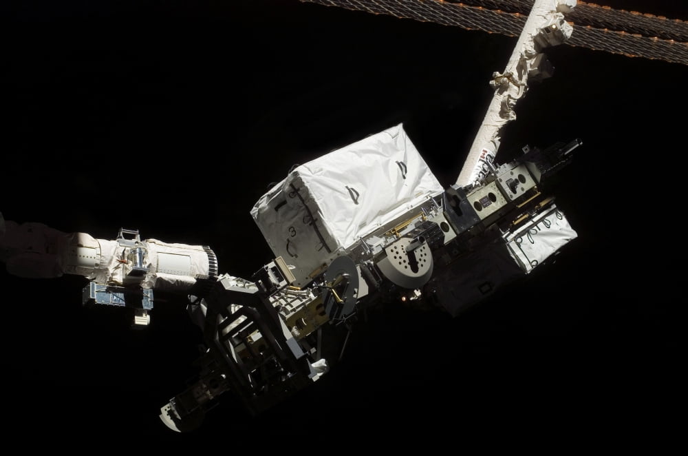The Remote Manipulator System robotic arm hands-off an external stowage platform Canvas Art - Stocktrek Images (34 x 23)