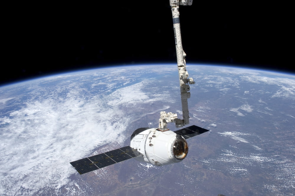 The SpaceX Dragon cargo craft in the grasp of the Canadarm2 Canvas Art - Stocktrek Images (35 x 23)