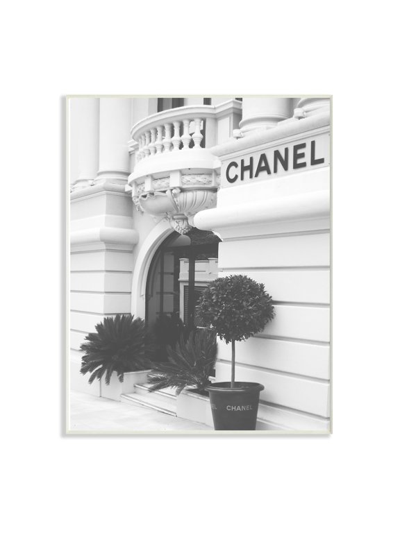 The Stupell Home Decor Black and White High Fashion Store Front Wall Plaque Art