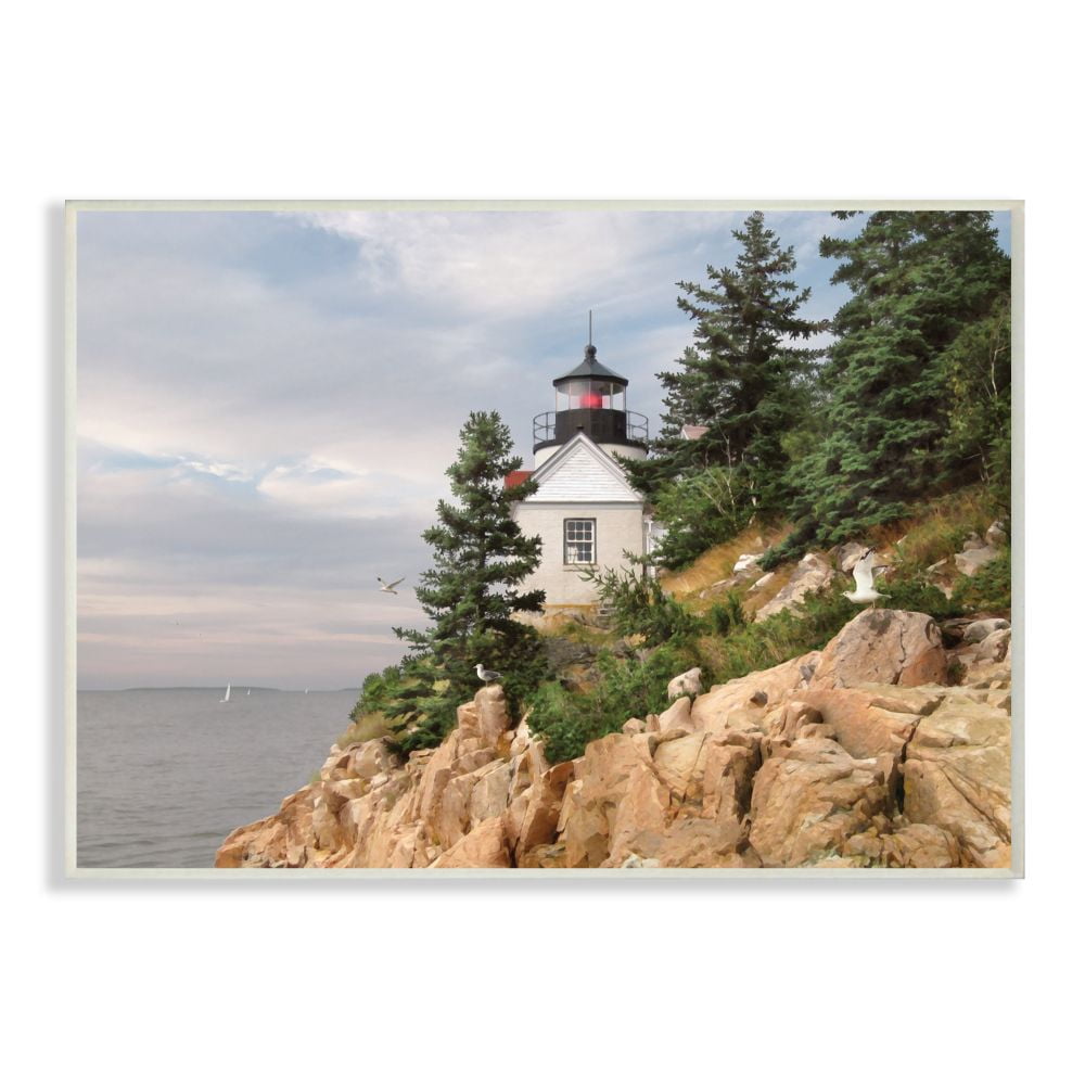 The Stupell Home Decor Collection Harbor Lighthouse Seaside Photograph with Fir Trees and Rocky Cliff Wall Plaque Art