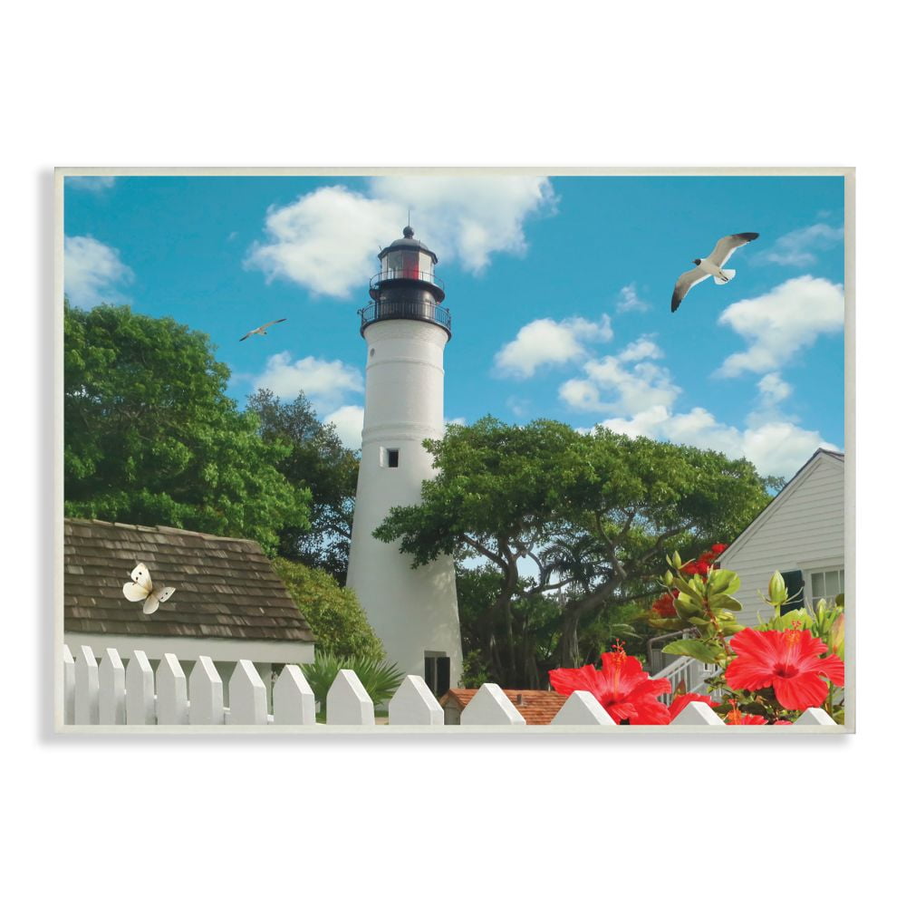 The Stupell Home Decor Collection Key West Light House with Picket Fence Butterfly and Seagull Wall Plaque Art