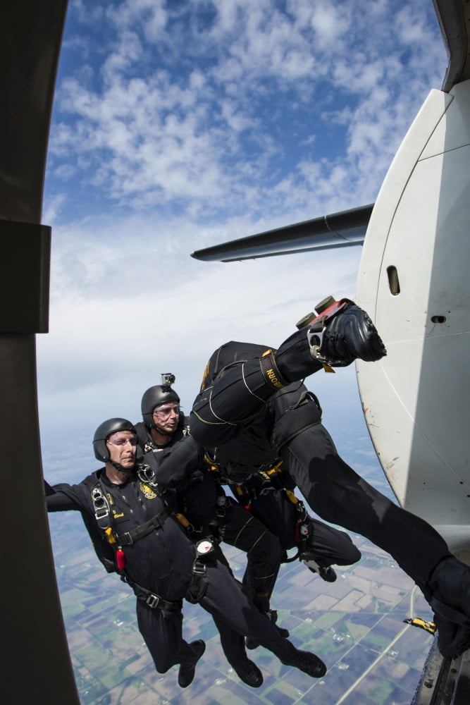 The US Army Black Knights display team exit a F-27 Friendship plane Canvas Art - Rob EdgcumbeStocktrek Images (12 x 17)