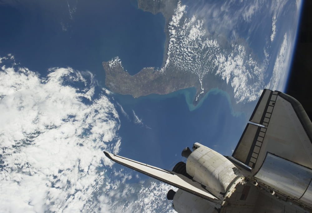 The aft part of space shuttle Endeavour backdropped against a part of Earth Canvas Art - Stocktrek Images (34 x 24)
