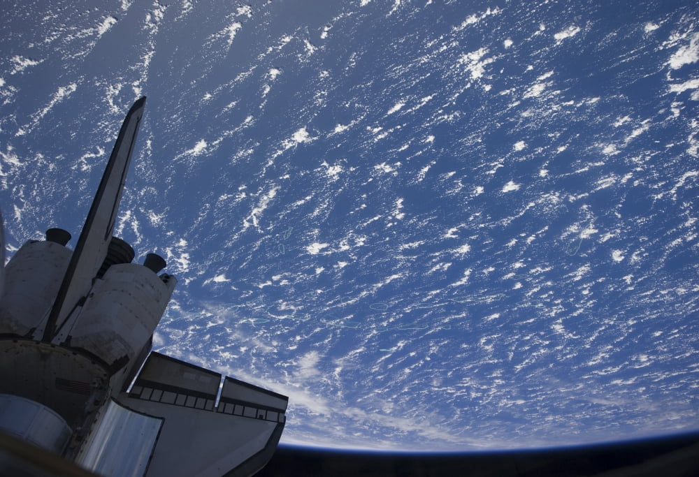 The aft section of space shuttle Discovery backdropped by planet Earth Canvas Art - Stocktrek Images (34 x 24)