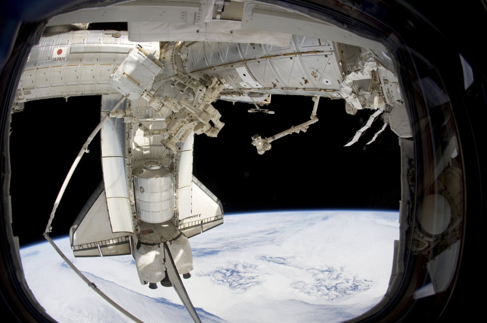 The docked space shuttle Discovery and Dextre Canvas Art - Stocktrek Images (34 x 23)