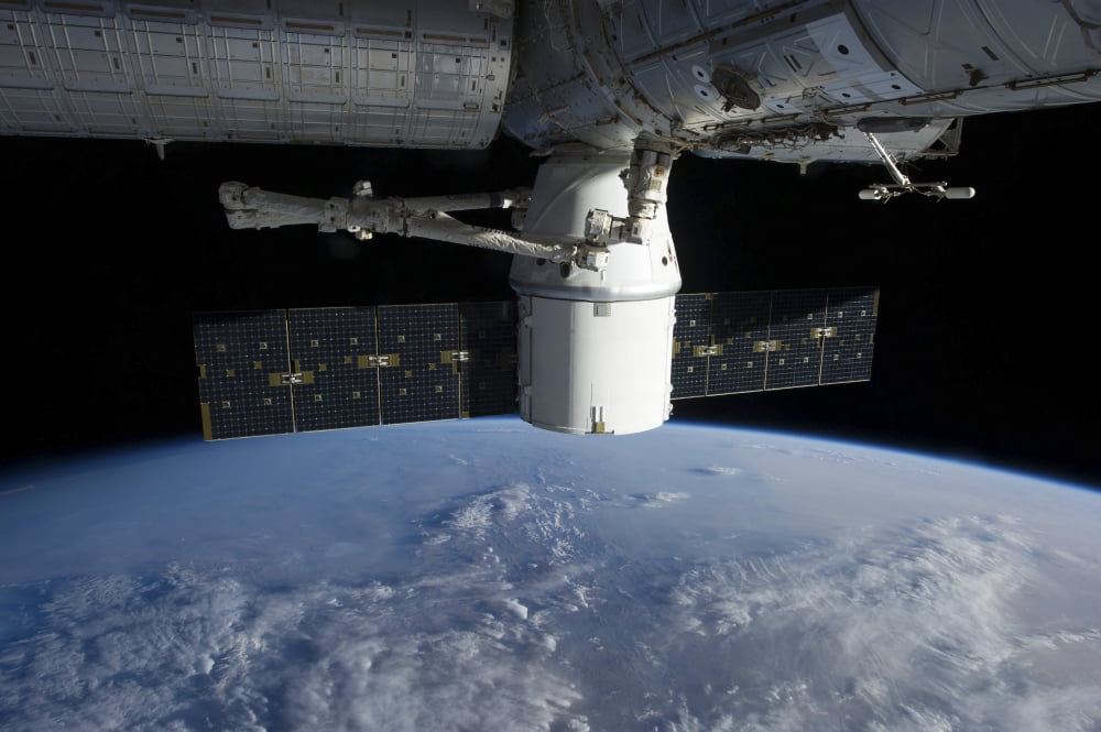 The docking of SpaceX Dragon to the International Space Station above Earth Canvas Art - Stocktrek Images (34 x 23)