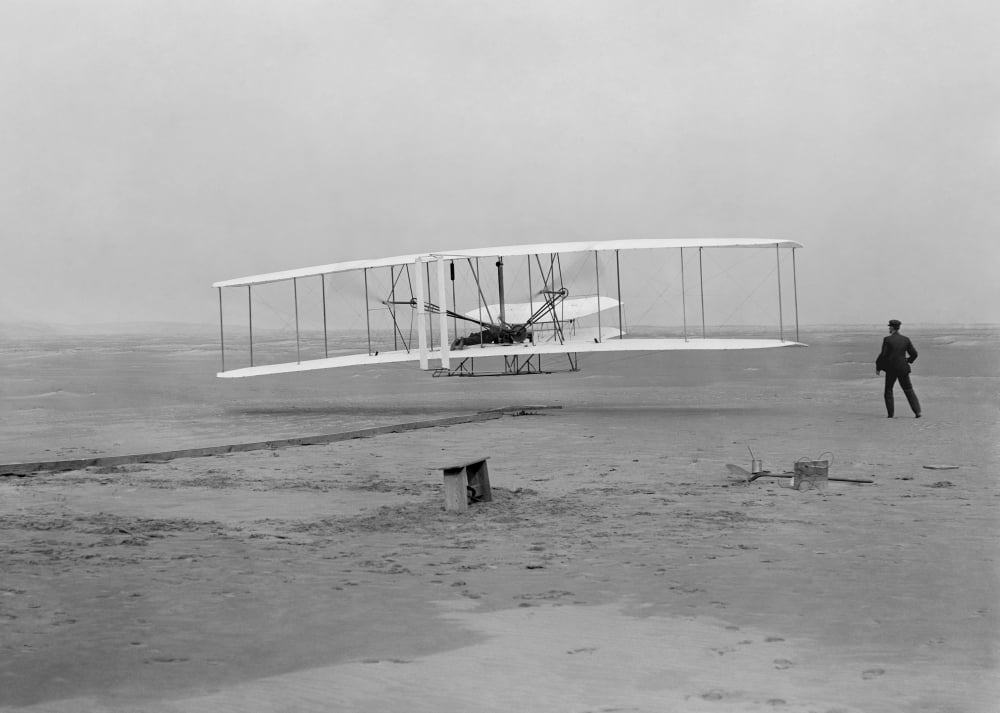 The first flight of the Wright Flyer in 1903 Canvas Art - John ParrotStocktrek Images (17 x 12)