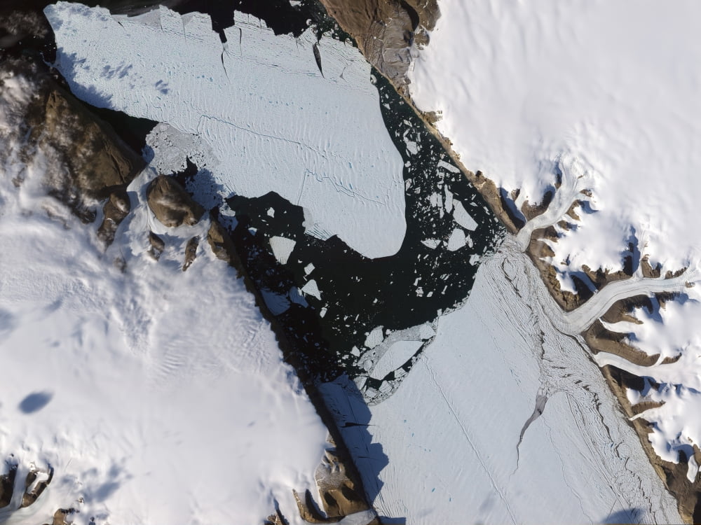 The ice island that calved off the Petermann Glacier in northwestern Greenland migrates down the fjord Canvas Art - Stocktrek Images (32 x 24)
