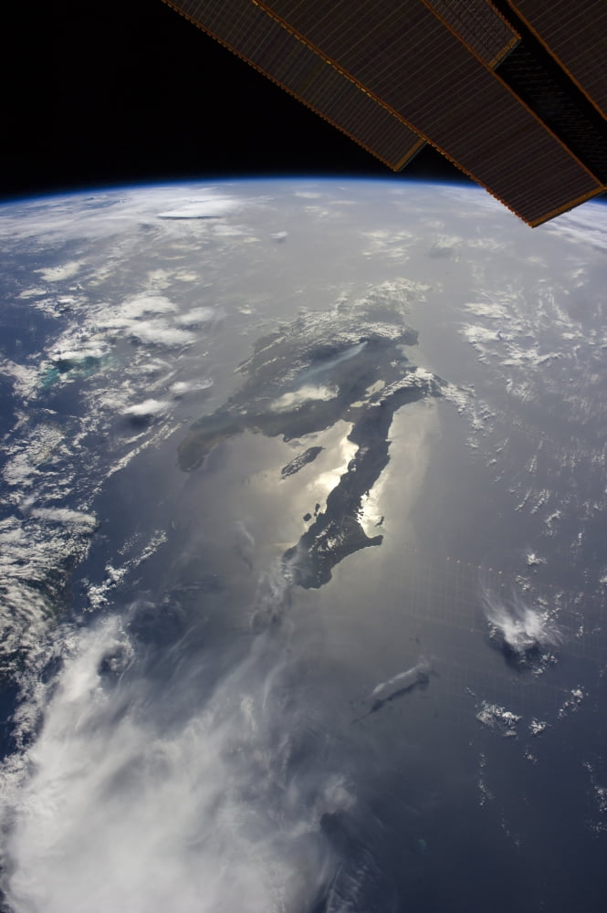 The island of Hispaniola with sunglint illuminating the peninsula of Haiti Canvas Art - Stocktrek Images (23 x 34)