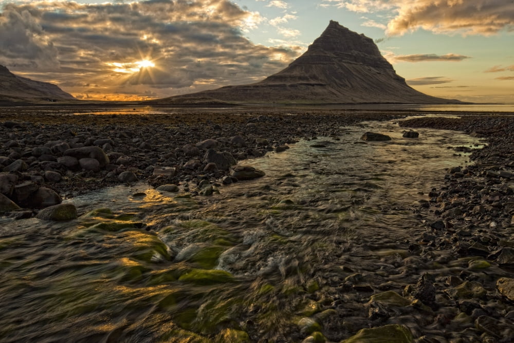 The mountain Kirkjufell rises above the ocean as the sun sets on the Snaefellsnes peninsula Iceland Canvas Art - Robert Postma Design Pics (17 x 11)