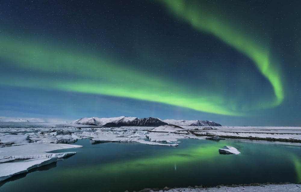 The northern lights dance over the glacier lagoon in Iceland Canvas Art - John DavisStocktrek Images (18 x 11)