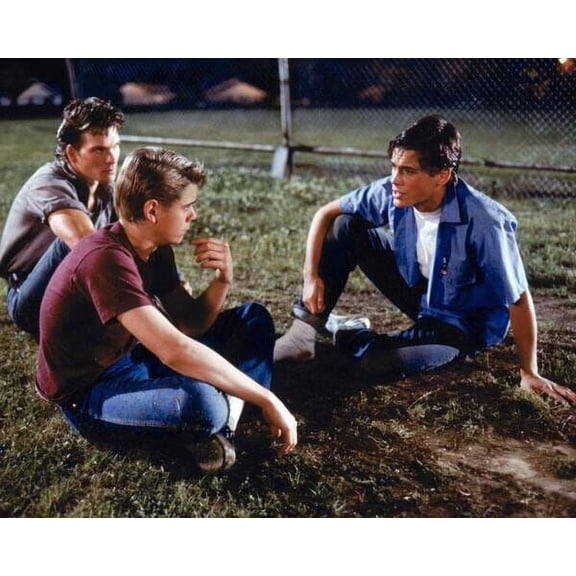 The outsiders Patrick Swayze C. Thomas Howell Rob Lowe sit on grass 24x30 poster