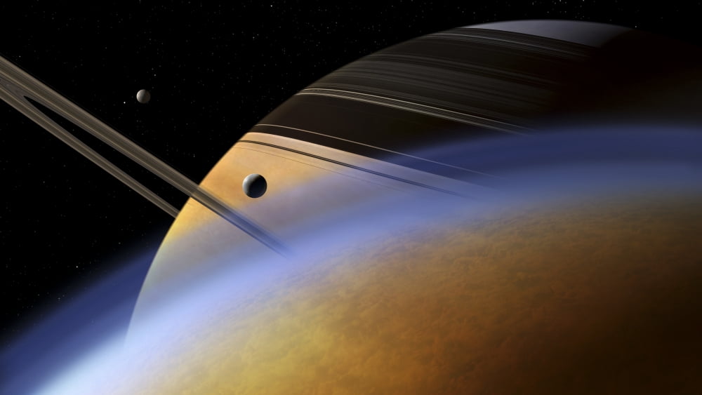 The ringed giant Saturn rises above the haze of Titan Canvas Art - Steven HobbsStocktrek Images (19 x 11)
