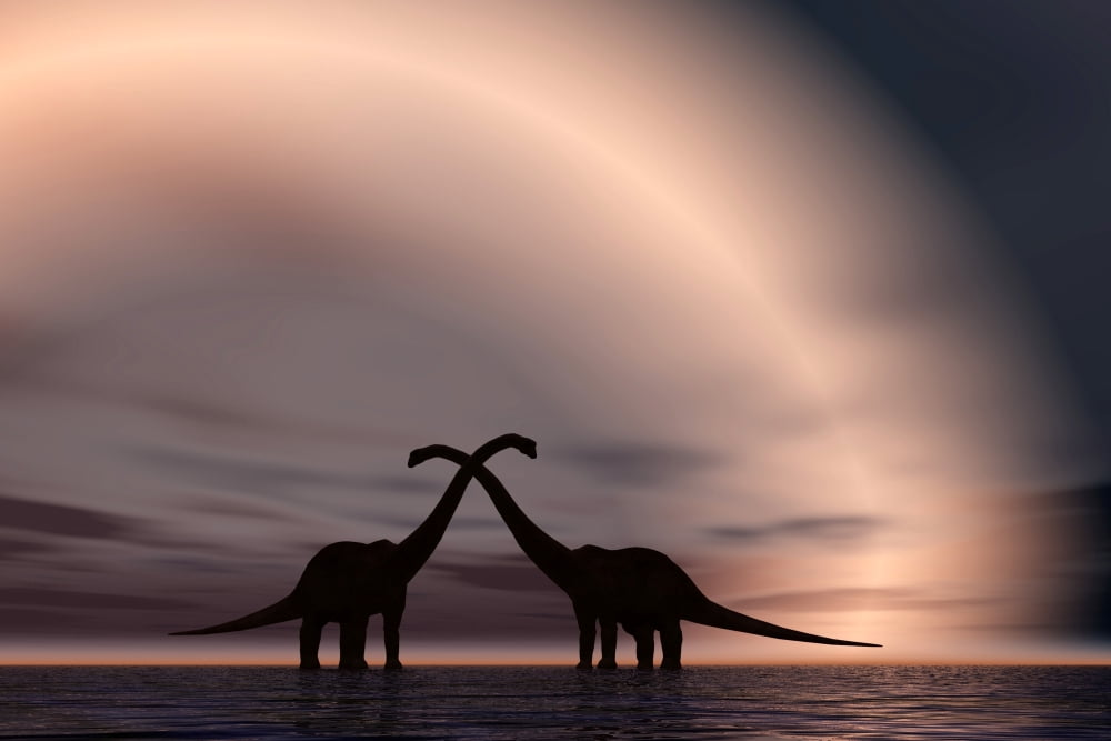 The silhouetted forms of a pair of courting sauropod dinosaurs Canvas Art - Mark StevensonStocktrek Images (35 x 24)
