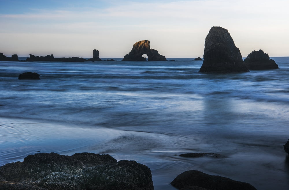 The sun comes up on sea stacks Cannon Beach Oregon United States of America Canvas Art - Robert L Potts Design Pics (19 x 12)