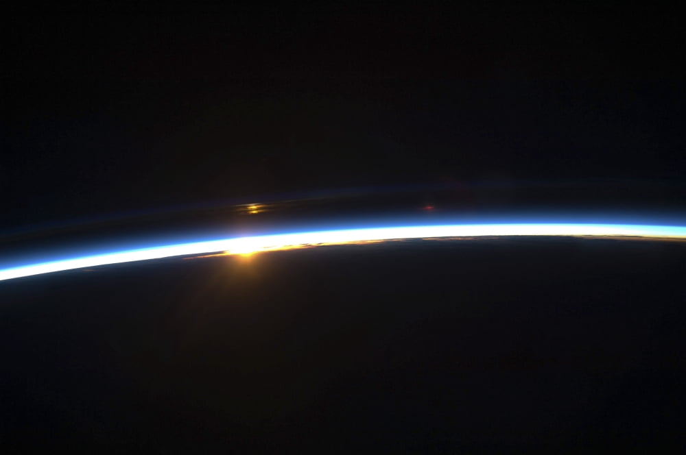 The thin line of Earths atmosphere and the rising sun Canvas Art - Stocktrek Images (34 x 23)