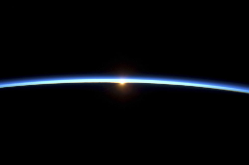 The thin line of Earths atmosphere and the setting sun Canvas Art - Stocktrek Images (34 x 23)