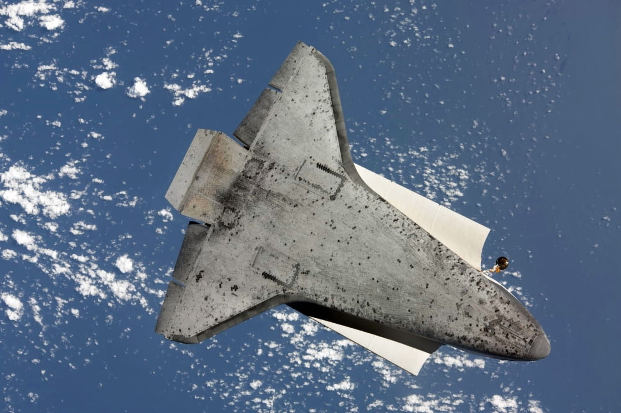 The underside of space shuttle Discovery Canvas Art - Stocktrek Images (34 x 23)