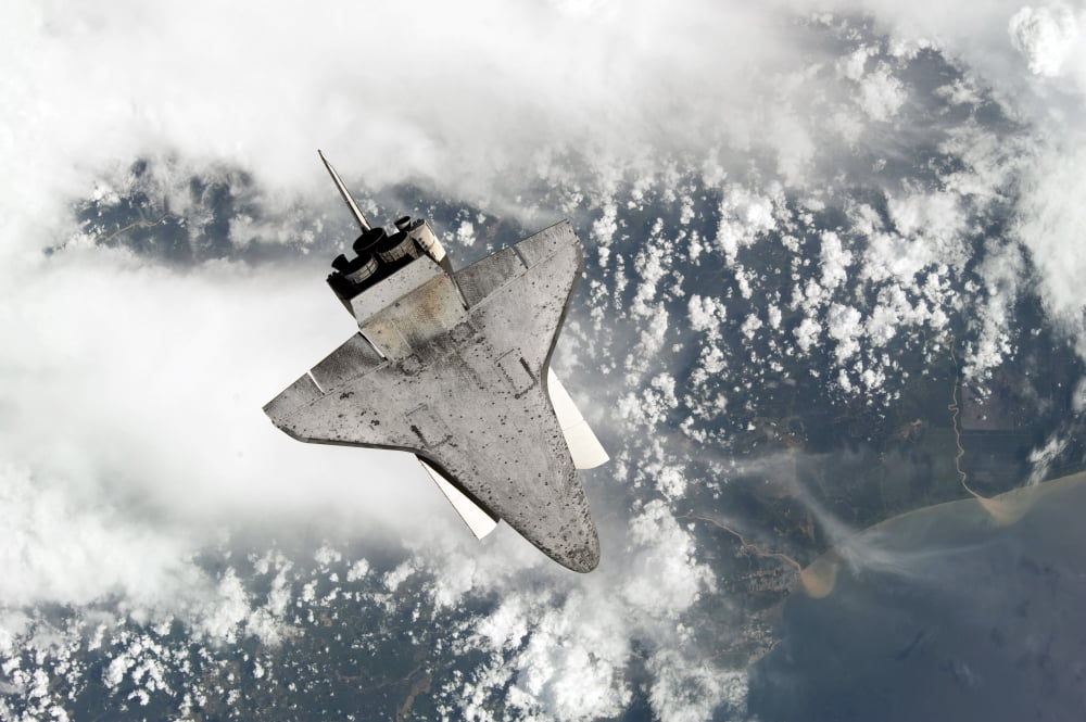 The underside of space shuttle Discovery as the shuttle approaches the International Space Station Canvas Art - Stocktrek Images (34 x 23)