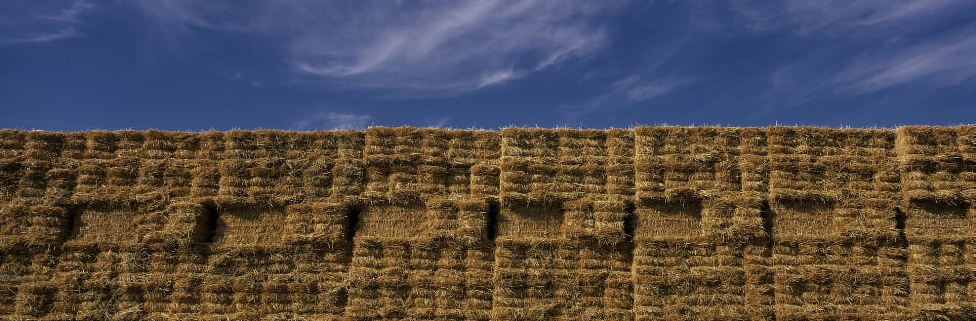 These are rectangular hay stacks piled up against a blue sky Canvas Art - Panoramic Images (27 x 9)