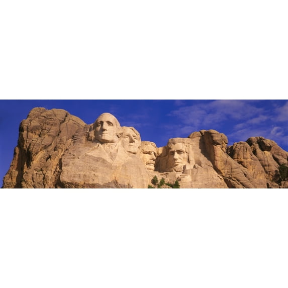 This is a close up view of Mount Rushmore National Monument against a blue sky It shows the four faces of George 12 x 39